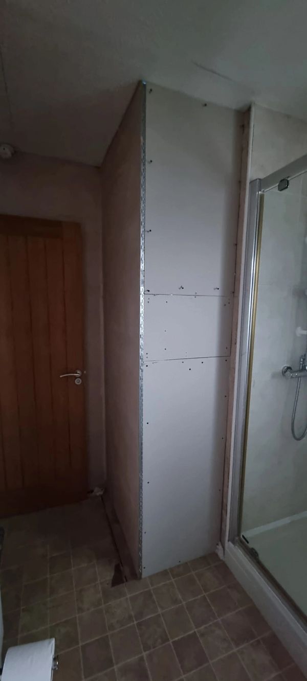 BEFORE: Main bathroom airing cupboard area fully boarded and prepared, ready for tiling.
