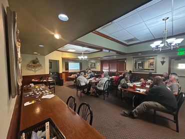 People attend a presentation in a small room.