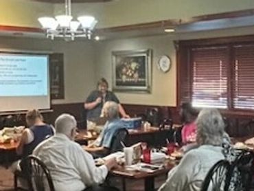 People attend a presentation in a small room.