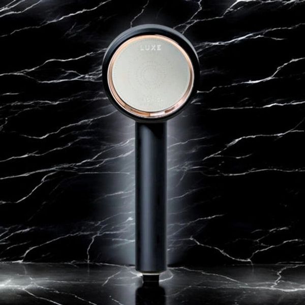 Sleek black and silver handheld showerhead against a marbled black background.