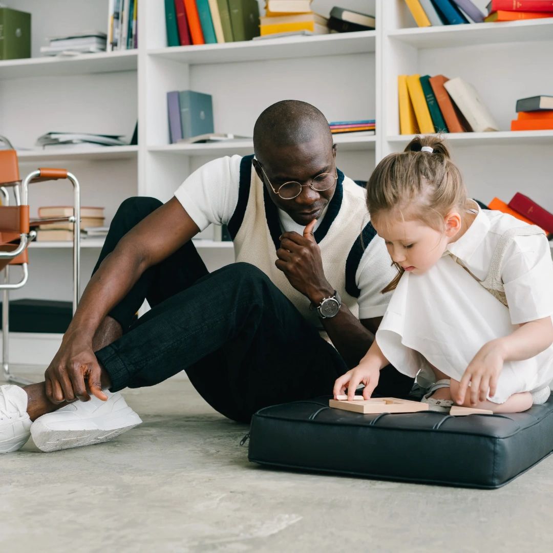 Image of a Parent supporting his child 