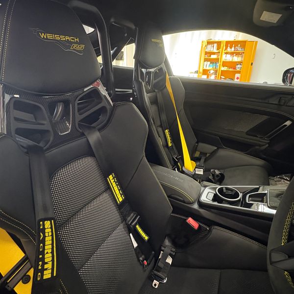 Interior of a Porsche with Weissach RS racing seats and Schroth Racing harnesses.