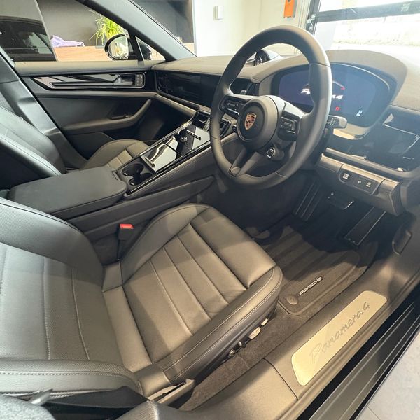 Luxury interior of a Porsche Panamera 4 with modern design and leather seats.