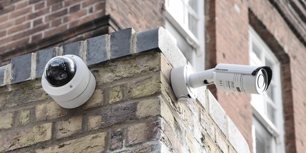 Security cameras installed on a brick wall