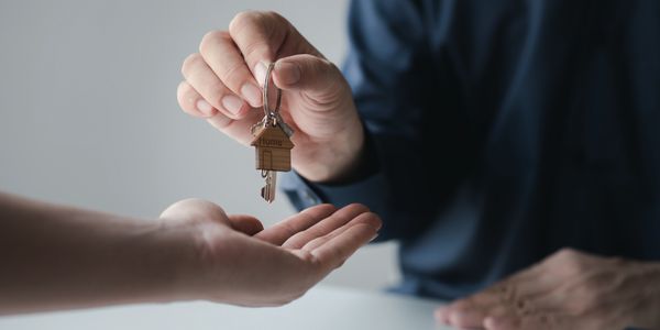 Agent handing over house keys, symbolizing trusted transactions with Beyond Borders Realty Mexico