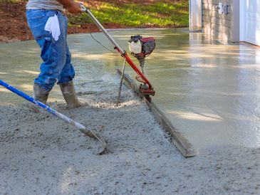Utilizing tamping machine to align compacted concrete on driveways