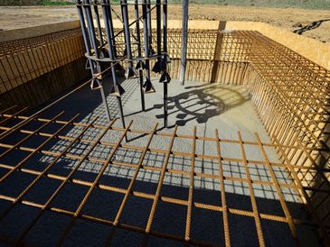 Freshly pumped concrete to cast strong bottom plate