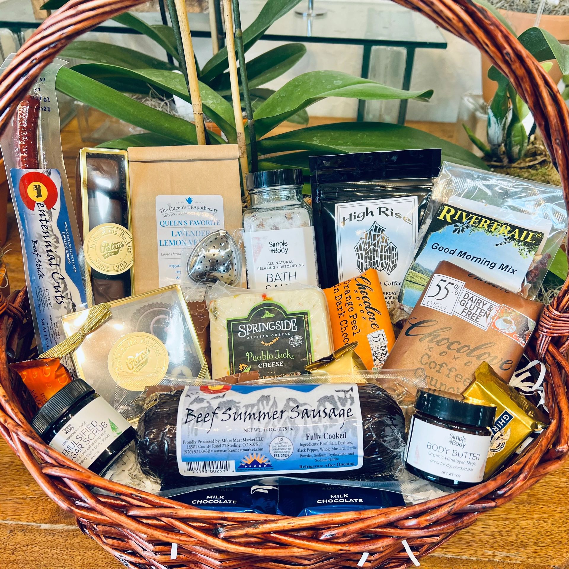 Gift basket with chocolate, lotion, sugar scrub, beef summer sausage, tea, coffee, cheese