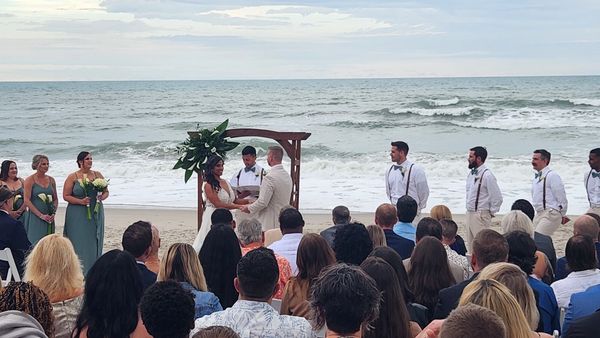 DJ Tony Signorino provides ceremony music and microphones for a wedding ceremony on the sand at Dayt