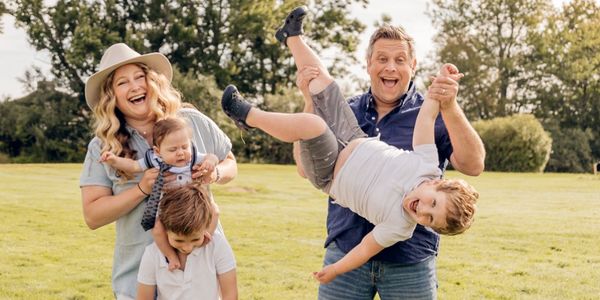 Happy family playing outdoors on a sunny day.
