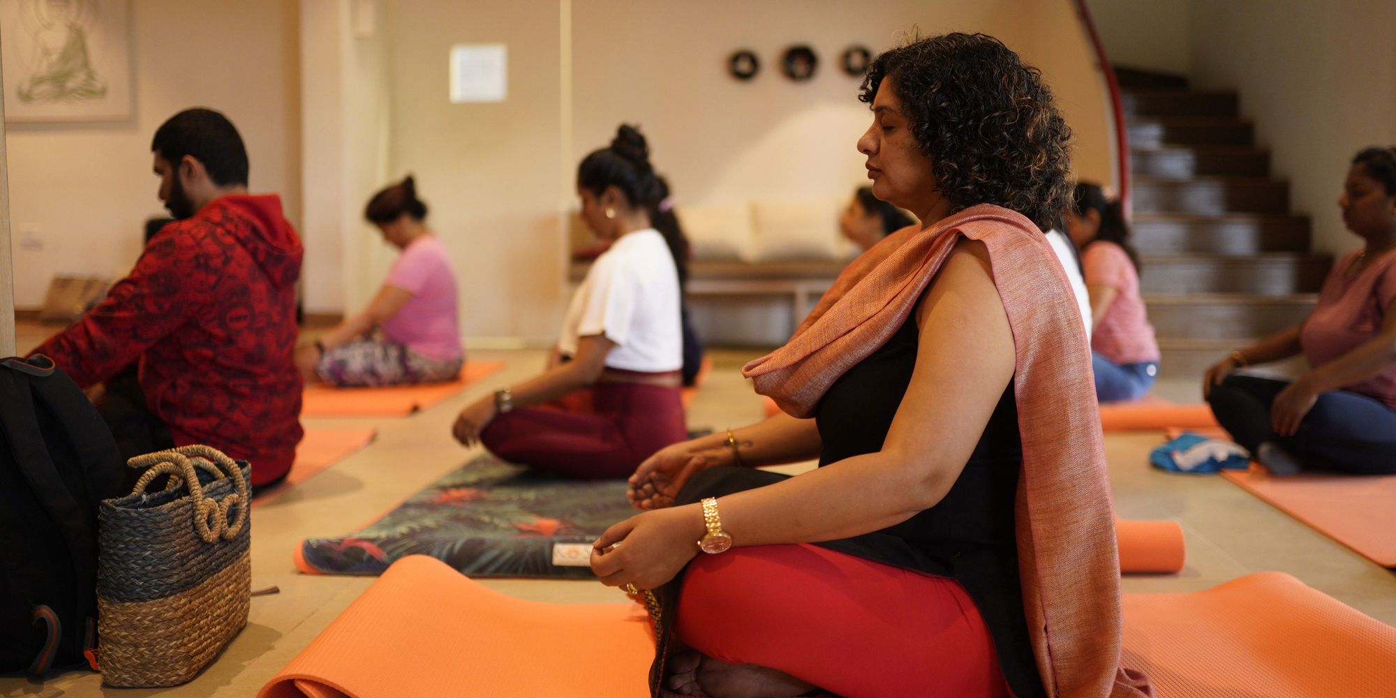 Stack of books next to pencils in a holder and a camera.