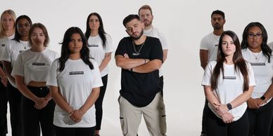 Music artist Nadiem posing with music video extras in his merch, Exception.