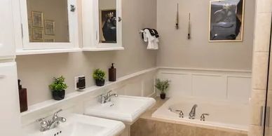 White towels, Rainfall shower head, textured bath mat, storage, hair dryer.