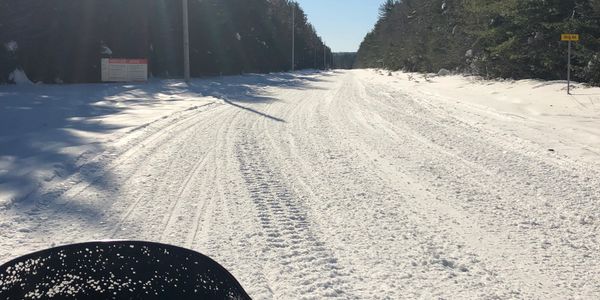 Viewing the Snowmobile trail condition while sitting on a snowmobile 