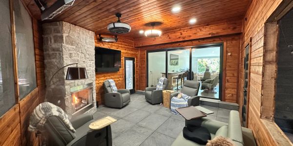 Cozy wooden cabin living room with stone fireplace.