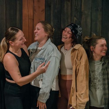 Group of four women smiling and laughing