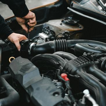 Close up hands of unrecognizable mechanic doing car service and maintenance.