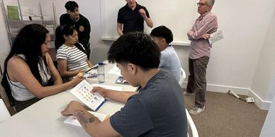 Students engaged in a lesson about driving terminology in English and Spanish  with instructors Davi