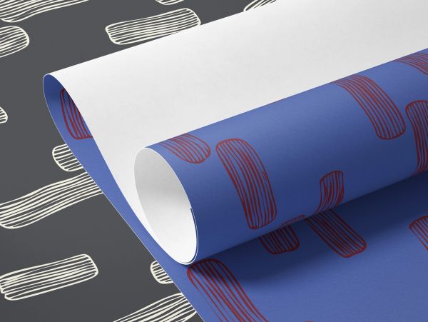 Rolled sheets of decorative patterned paper.