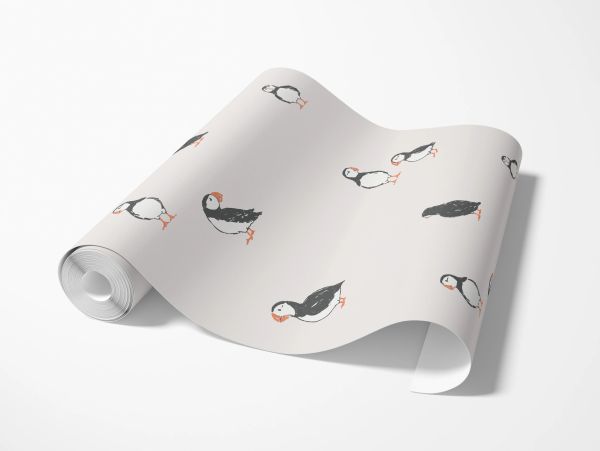 Roll of wallpaper with puffin bird illustrations.
