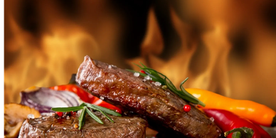 Juicy grilled steaks with herbs and peppers against a fiery background.