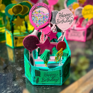 birthday popup card with balloons that are a shaker card with glitter inside.