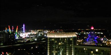 View of lights of Universal Studios, and surrounding attractions at night from high hotel window.