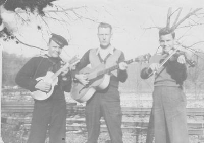 My dad on fiddle with two other men on mandolin and guitar around the late 1940's, early 1950's.
