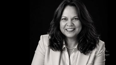 Black and white portrait of a woman smiling.