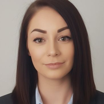 Professional woman with straight dark hair and a nose ring.