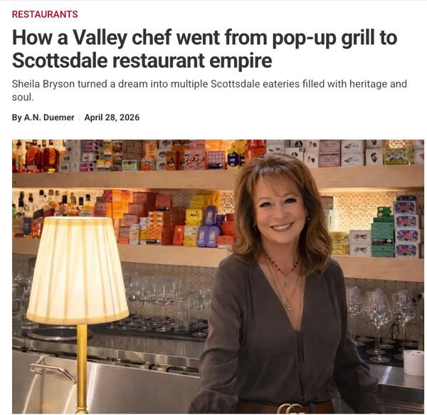 Sheila Bryson, a chef, stands smiling in her Scottsdale restaurant bar area.