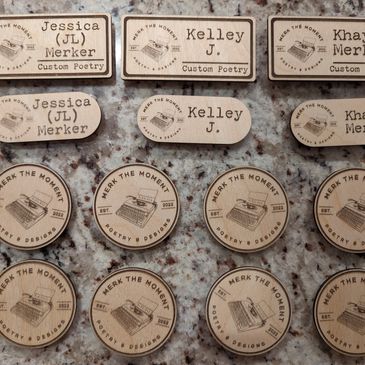 Wooden business tags engraved with names and a typewriter logo for Merk the Moment.