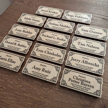 Wooden name tags for moderators and panelists at University of Tampa event in 2024.