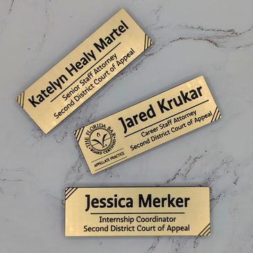 Three brass nameplates for staff at the Second District Court of Appeal.