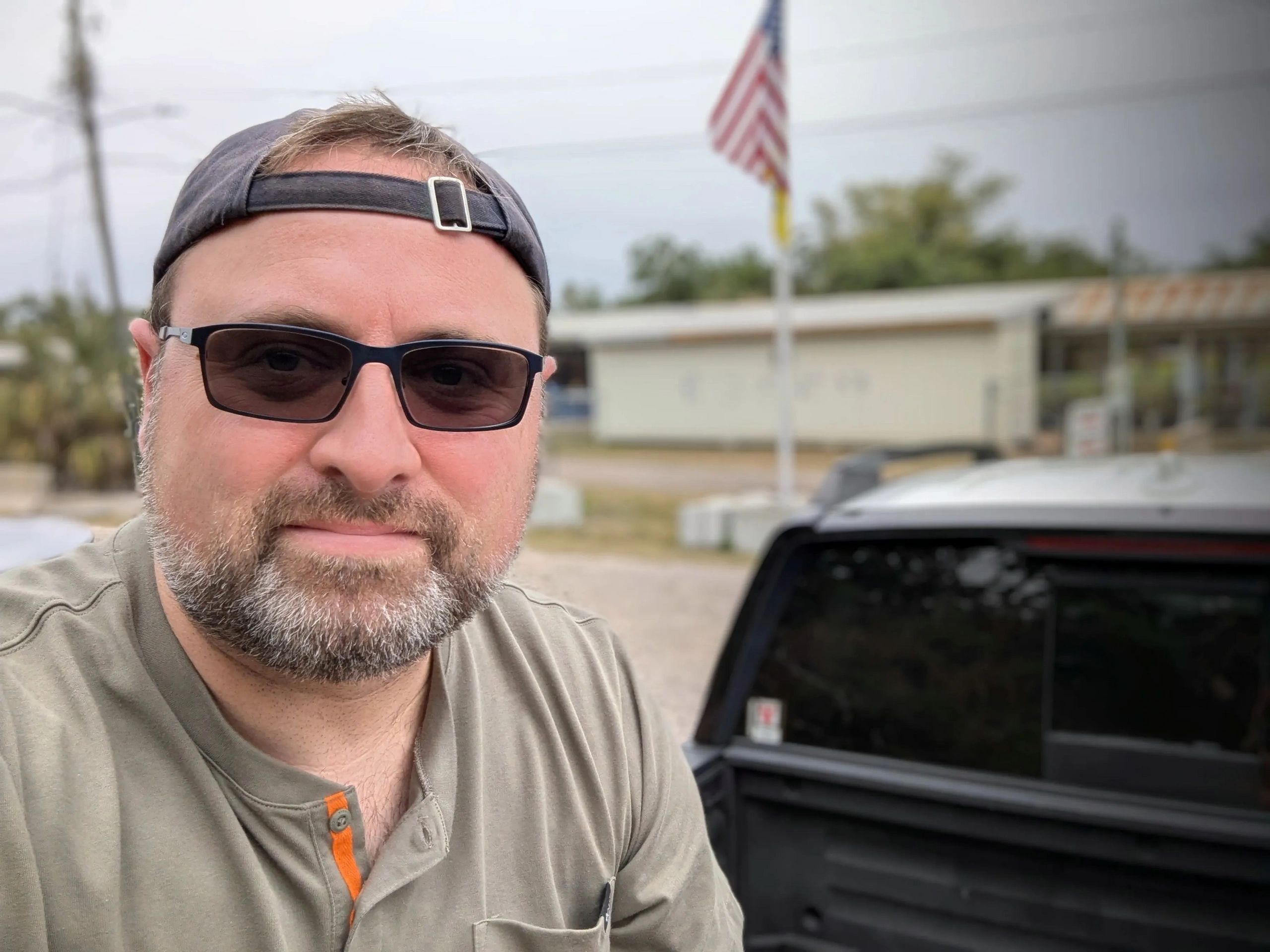 Picture of Jared Krukar sitting outside the Wyoming Antelope Club, a local gun range.