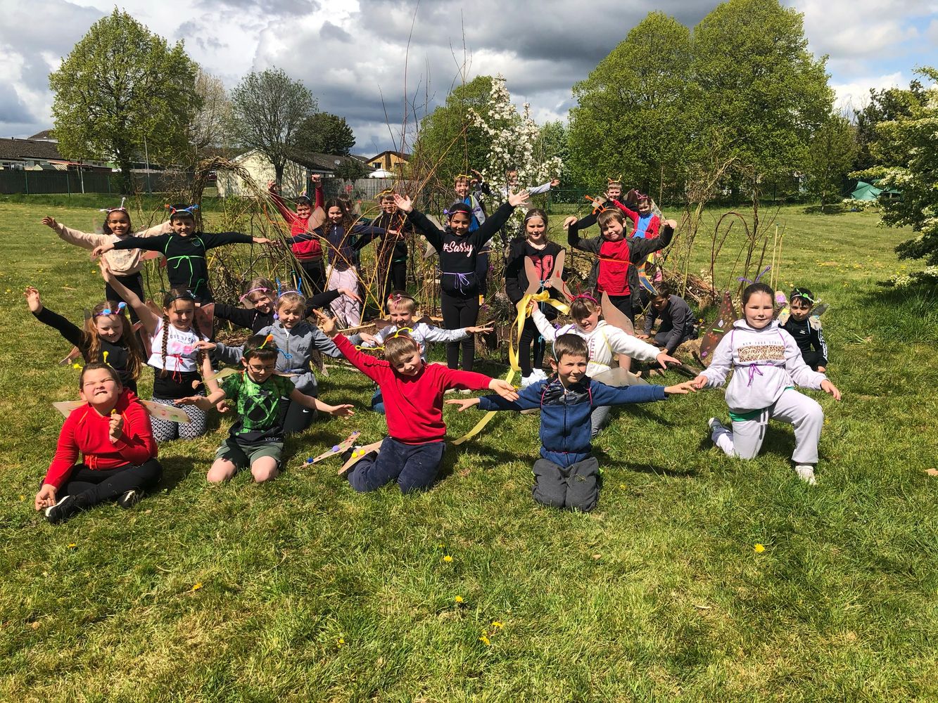 Children enjoying drama class together outside in the field