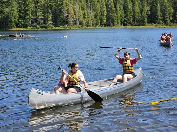campers riding in canoe, winning race