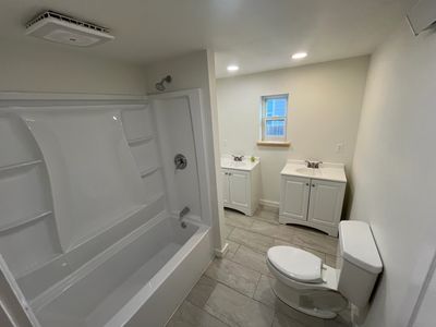 Full bathroom renovation in Routt County featuring new vanity, lighting, and flooring.