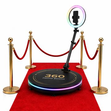360 photo booth platform with ring light on red carpet.