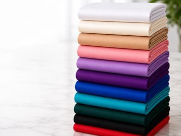 Stack of neatly folded colorful fabrics.