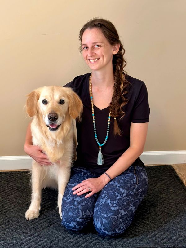 Positive dog trainer, Lauren, and Rylee facing the camera with smiles.