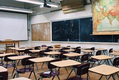 Empty classroom with desks and chairs.