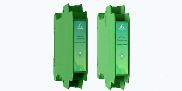 Two green industrial transducers side by side.
