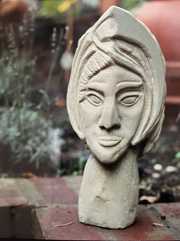 Stone sculpture of a stylized human face.