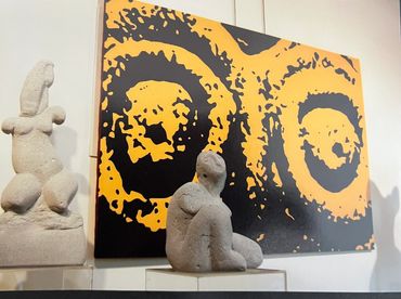 Abstract stone sculptures with a vibrant modern painting.
