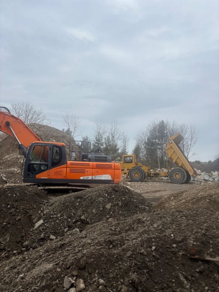 Stack of books next to pencils in a holder and a camera.