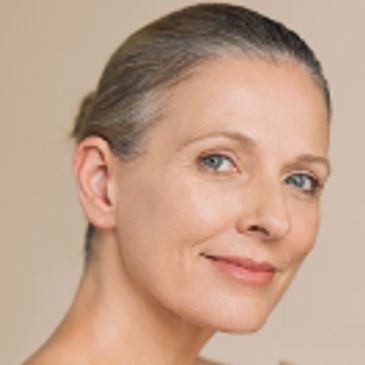 Close-up portrait of a mature woman with a serene expression.
