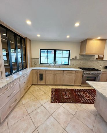 Modern kitchen with wooden cabinets and tiled floor.