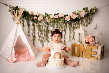 A Baby Infront Of A Cake In Pink Theme