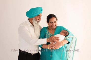 an elderly couple with their newborn grandchild 